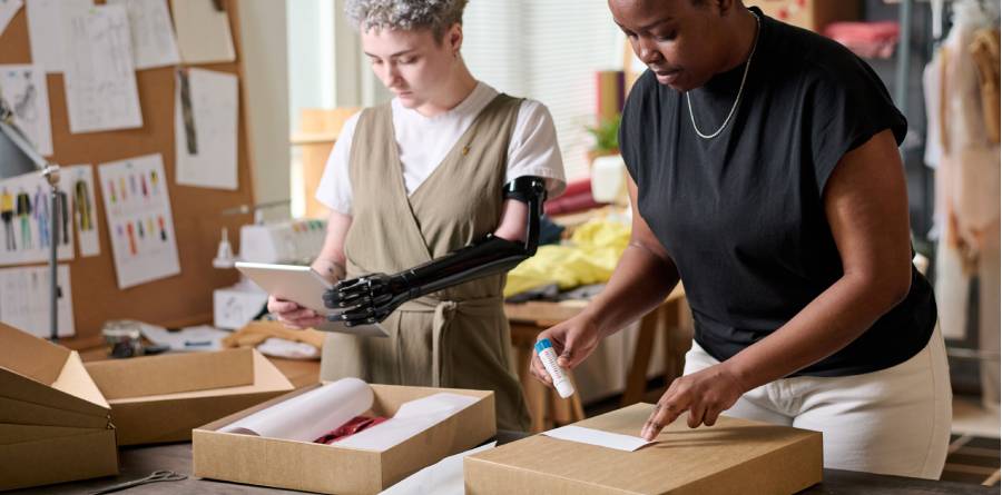Woman sealing a cardboard packaging box for secure shipping in the UK